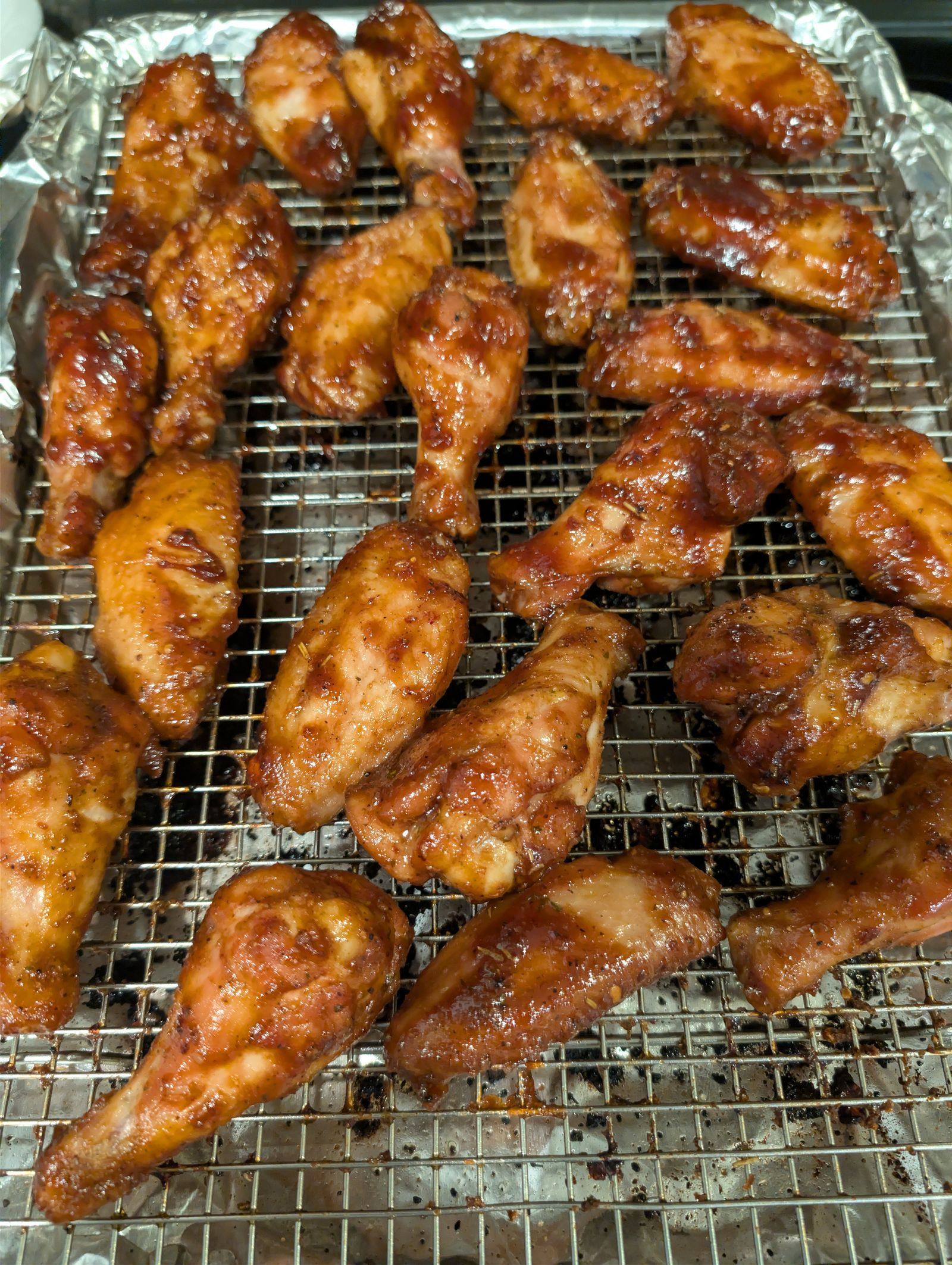 Sauced smoked chicken wings on a wire rack